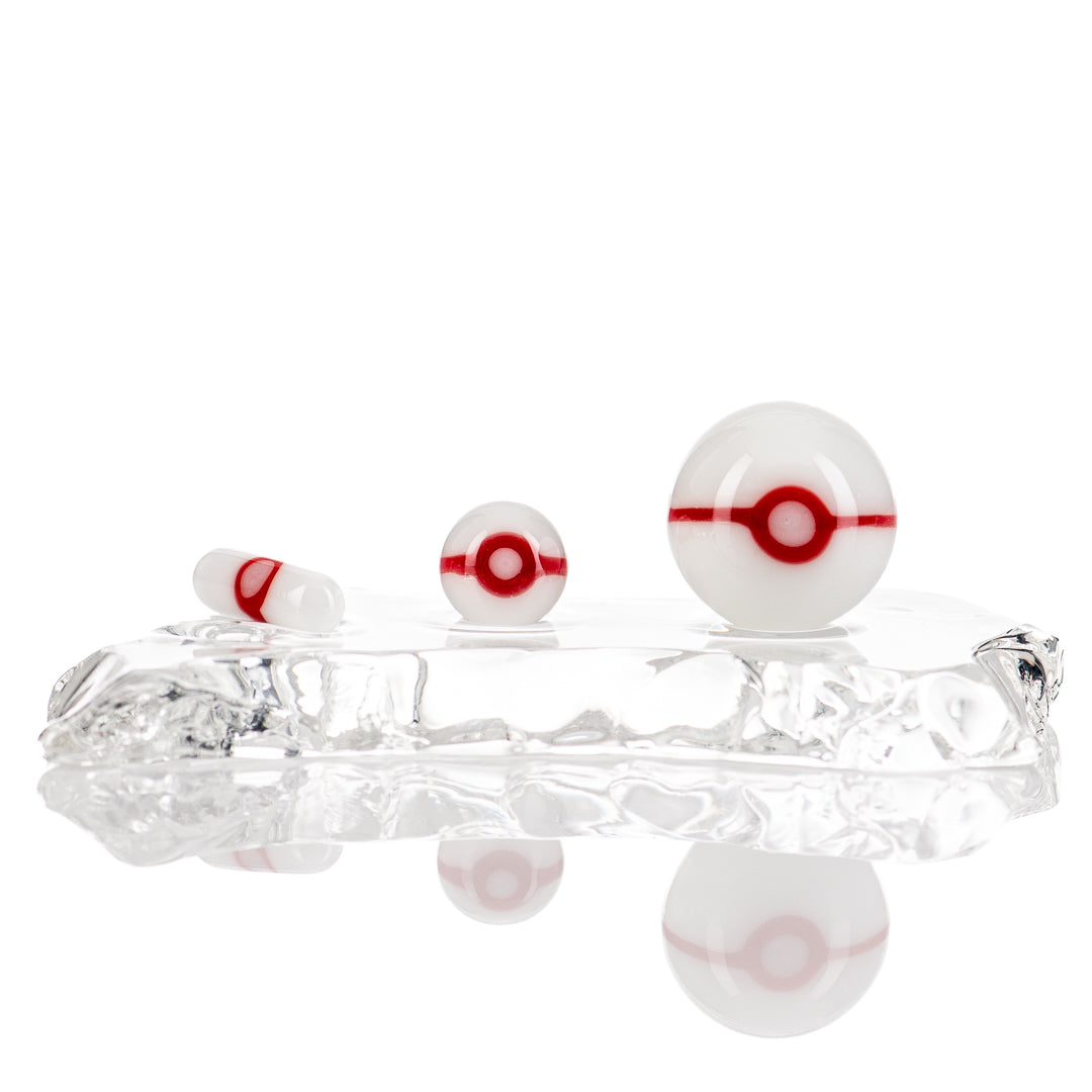 Three-piece Pokeball glass terp slurper set by Ganja Grimmlin Glass, featuring colorful Pokeball designs and textured glass surfaces.