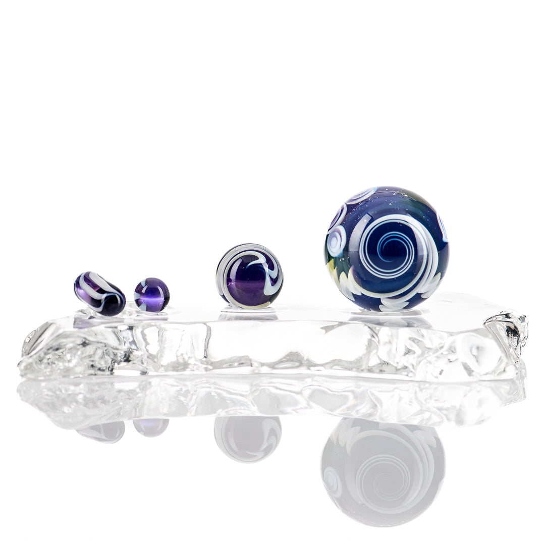 Indo Glass UV Dotstack Slurper Set featuring colorful glass slurpers with UV-reactive designs for dabbing and vaporization.