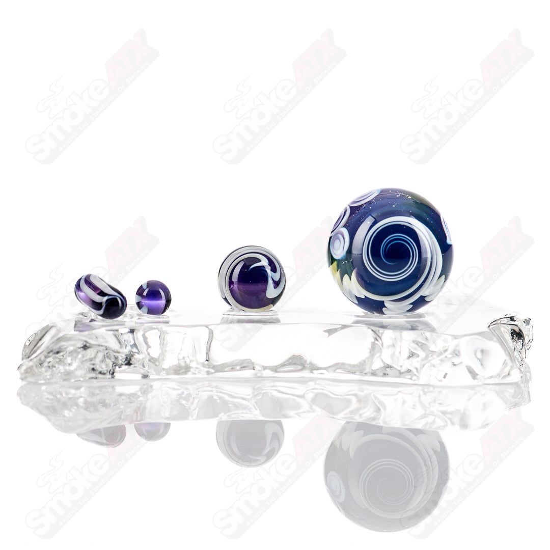 Indo Glass UV Dotstack Slurper Set featuring colorful glass tools on a display surface.