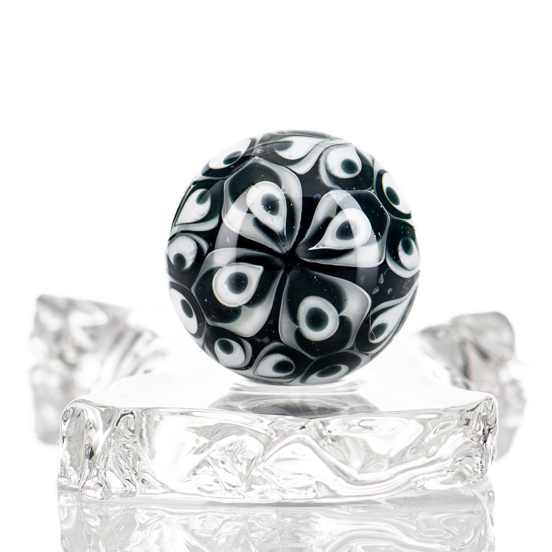 Black Magic UV Pinwheel Top marble by Indo Glass, colorful glass marble with swirling pinwheel design on a white background