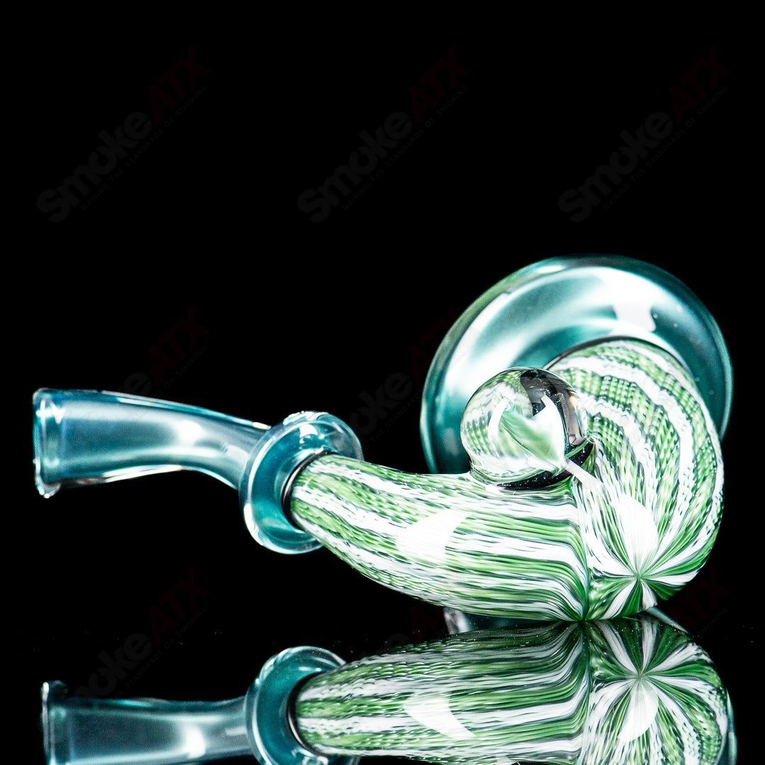JMass Sherlock glass pipe featuring a Neptunium Sherlock Collab design, clear glass with intricate detailing.